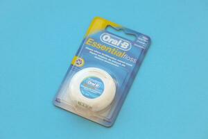 KYIV, UKRAINE - JULY 7, 2023 Oral-B Essentail Floss. Waxed dental floss in round case photo