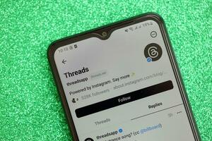 KYIV, UKRAINE - JULY 7, 2023 Threads by Meta application on display of Samsung smartphone lying on table photo