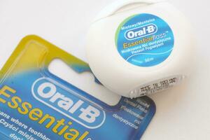 KYIV, UKRAINE - JULY 7, 2023 Oral-B Essentail Floss. Waxed dental floss in round case photo