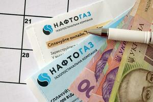 KYIV, UKRAINE - JULY 7, 2023 Naftogaz utility bill document with ukrainian hryvnias money photo