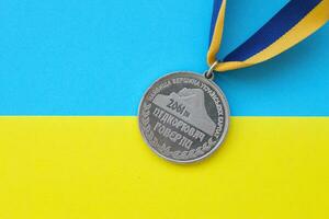 KYIV, UKRAINE - MAY 4, 2022 Medal for the person who conquered Mount Hoverla photo
