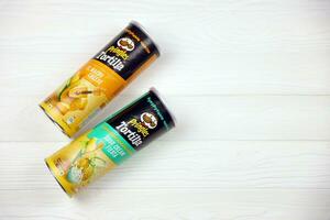 Pringles cylinder tubes with Tortilla el nacho cheese and sour cream fiesta flavour. Pringles is a brand of potato snack chips owned by Kellogg Company photo