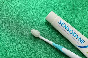 KYIV, UKRAINE - MAY 4, 2022 Sensodyne fluorine or fluor is a daily fluoride toothpaste photo