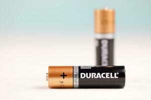 Duracell batteries on white background. Duracell is an American brand of batteries and smart power solutions manufactured by Procter and Gamble photo