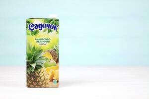 KHARKOV, UKRAINE - DECEMBER 18, 2020 Sadochok pineapple and apple juice of Sandora company. Sandora LLC is Ukrainian producer of juices and carbonated drinks owned by American company PepsiCo photo