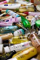 KHARKOV, UKRAINE - JANUARY 2, 2021 Many used bottles and jars for different brandy feminines. Containers for shampoo and lotions, cans for creams and masks photo