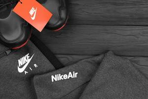 KHARKOV, UKRAINE - DECEMBER 20, 2020 Nike brand clothes and shoes sport wear kit. Nike is American multinational corporation engaged in manufacturing and worldwide marketing of clothes and footwear photo