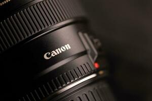 KHARKOV, UKRAINE - JANUARY 21, 2021 Canon EF 85mm 1.8 lens on fabric background. Detailed photo of Canon brand product