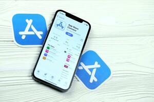 KHARKOV, UKRAINE - MARCH 5, 2021 App store connect icon and application from App store on iPhone 12 pro display screen on white table photo