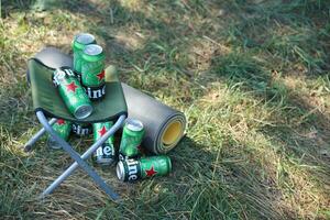 KHARKOV, UKRAINE - JULY 31, 2021 Green tin cans of Heineken lager beer produced by the Dutch brewing company Heineken N.V. photo