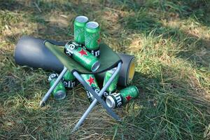 KHARKOV, UKRAINE - JULY 31, 2021 Green tin cans of Heineken lager beer produced by the Dutch brewing company Heineken N.V. photo