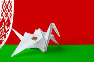 Belarus flag depicted on paper origami crane wing. Handmade arts concept photo