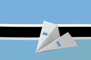 Botswana flag depicted on paper origami airplane. Handmade arts concept photo