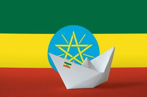 Ethiopia flag depicted on paper origami ship closeup. Handmade arts concept photo