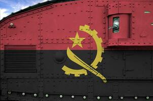 Angola flag depicted on side part of military armored tank closeup. Army forces conceptual background photo