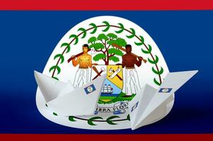 Belize flag depicted on paper origami airplane and boat. Handmade arts concept photo