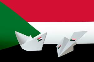 Sudan flag depicted on paper origami airplane and boat. Handmade arts concept photo