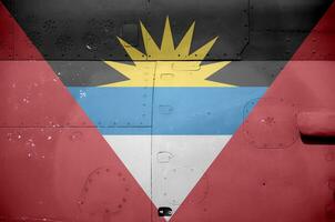 Antigua and Barbuda flag depicted on side part of military armored helicopter closeup. Army forces aircraft conceptual background photo