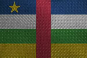 Central African Republic flag depicted in paint colors on old brushed metal plate or wall closeup. Textured banner on rough background photo