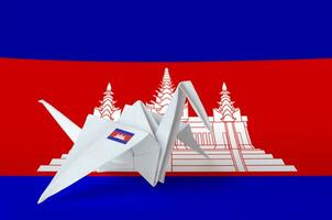 Cambodia flag depicted on paper origami crane wing. Handmade arts concept photo