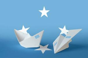 Micronesia flag depicted on paper origami airplane and boat. Handmade arts concept photo