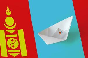 Mongolia flag depicted on paper origami ship closeup. Handmade arts concept photo