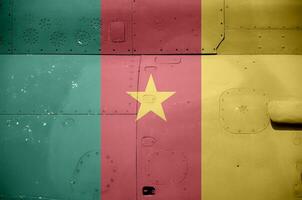 Cameroon flag depicted on side part of military armored helicopter closeup. Army forces aircraft conceptual background photo