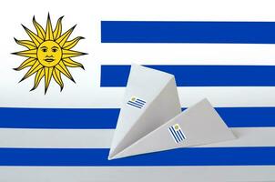 Uruguay flag depicted on paper origami airplane. Handmade arts concept photo