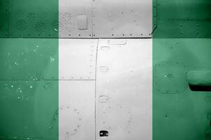 Nigeria flag depicted on side part of military armored helicopter closeup. Army forces aircraft conceptual background photo