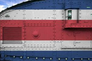 Costa Rica flag depicted on side part of military armored tank closeup. Army forces conceptual background photo