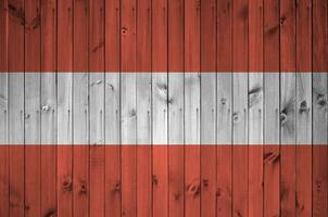 Austria flag depicted in bright paint colors on old wooden wall. Textured banner on rough background photo