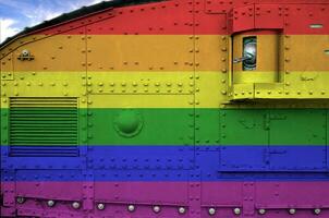 LGBT community flag depicted on side part of military armored tank closeup. Army forces conceptual background photo