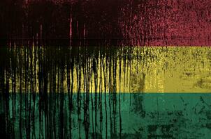 Bolivia flag depicted in paint colors on old and dirty oil barrel wall closeup. Textured banner on rough background photo