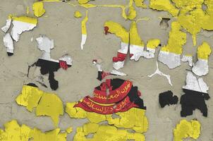 Brunei Darussalam flag depicted in paint colors on old obsolete messy concrete wall closeup. Textured banner on rough background photo