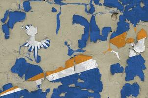 Marshall Islands flag depicted in paint colors on old obsolete messy concrete wall closeup. Textured banner on rough background photo