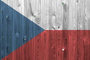 Czech flag depicted in bright paint colors on old wooden wall. Textured banner on rough background photo