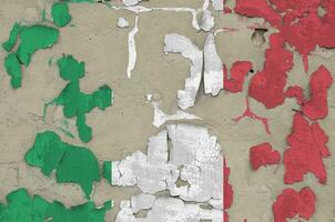 Italy flag depicted in paint colors on old obsolete messy concrete wall closeup. Textured banner on rough background photo