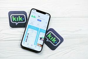 KHARKOV, UKRAINE - MARCH 5, 2021 Kik icon and application from App store on iPhone 12 pro display screen on white table photo