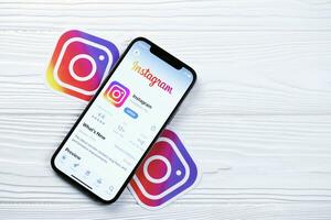 KHARKOV, UKRAINE - MARCH 5, 2021 Instagram icon and application from App store on iPhone 12 pro display screen on white table photo