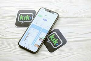 KHARKOV, UKRAINE - MARCH 5, 2021 Kik icon and application from App store on iPhone 12 pro display screen on white table photo