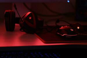 KYIV, UKRAINE - JULY 7, 2023 A4Tech Bloody G501 gaming headphones with microphone on table photo