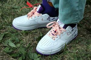 KYIV, UKRAINE - JULY 7, 2023 Fashion Sneakers Nike Air Force 1 on grass photo