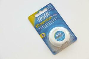 KYIV, UKRAINE - JULY 7, 2023 Oral-B Essentail Floss. Waxed dental floss in round case photo