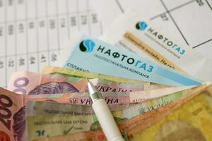 KYIV, UKRAINE - JULY 7, 2023 Naftogaz utility bill document with ukrainian hryvnias money photo