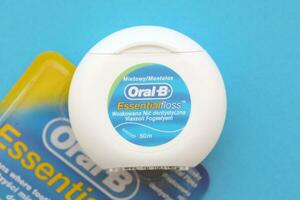 KYIV, UKRAINE - JULY 7, 2023 Oral-B Essentail Floss. Waxed dental floss in round case photo