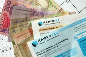 KYIV, UKRAINE - JULY 7, 2023 Naftogaz utility bill document with ukrainian hryvnias money photo