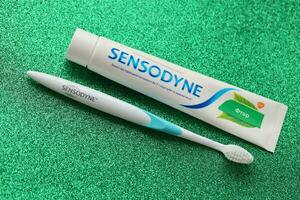 KYIV, UKRAINE - MAY 4, 2022 Sensodyne fluorine or fluor is a daily fluoride toothpaste photo