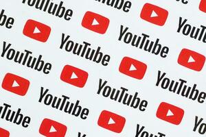 Youtube pattern printed on paper with small youtube logos and inscriptions. YouTube is Google subsidiary and American most popular video-sharing platform photo