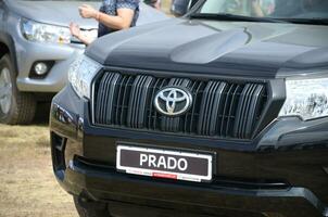 Toyota prado logo in black car front part close up outdoors photo