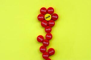 Flower of many red caps with coca cola logo on yellow background photo